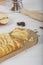 Close-up of Portion of apple pie on wooden cutting board with various ingredients. vertical image