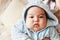 Close-up portrait of 2 month old newborn mixed race Asian Caucasian boy. Natural indoor lighting. Cool tones