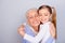 Close up portrait of adorable small lovely sweet charming beautiful girl hugging her careful attentive with white hair granny