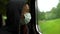 Close-up Portrait of an adult woman in a medical face mask riding a train, protecting against infection with the covid