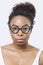 Close-up portrait of African American young woman wearing novelty glasses over white background