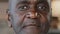 Close-up portrait african man concentrated human male wrinkled stubbly face american adult 50s retiree businessman