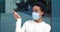 Close-up portrait african mixed race woman girl female patient wears medical protective surgical mask on face points