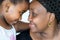 Close up portrait of african mother and child joining heads.