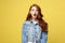 Close up Portrait amaze young beautiful attractive redhair girl shocking with something. Isolated on Bright Yellow