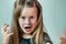 Close up portrait of angry shouting child girl looking aggressively in camera