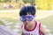 Close-up portrait Asian kids, Caucasian boy little child standing wearing a white vest and blue goggle making a smiling funny face