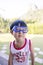 Close-up portrait Asian kids, Caucasian boy little child standing wearing a white vest and blue goggle making a smiling funny face