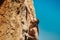 Close up portrait athletic man climber looking up with tense face and gripping hold