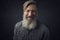 Close up portrait of an attractive happy bearded man on a black background