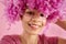 Close up of portrait of attractive happy darkskinned girl with soft pink curly wig