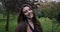 Close up portrait of attractive woman in park. Face of young woman in coat