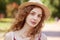 Close up portrait of attractive young lady in straw hat. Foxy haired charming woman with brown eyes looking at camera with gentle