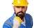 Close up portrait of bearded angry man builder in yellow helmet and blue uniform threatening with fist over white background