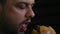 Close up portrait of bearded man eating sandwich. Real time full hd video footage. Fast food