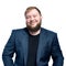 Close-up portrait of a bearded man. Happy boss. Blue jacket in business look