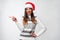 Close up portrait beautifiul caucasian woman in red Santa hat on white studio background. Christmas and New Year holiday concept