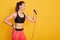 Close up portrait of beautiful athletic girl performs exercises using resistance band, young Caucasian girl pumping biceps