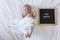 close up portrait of a beautiful baby on white background at home with a vintage letter board with message: one month