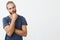 Close up portrait of beautiful bearded man with stylish hairstyle and clothes looking aside and thinking about room