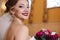 Close-up portrait of beautiful bride shines with happiness. A snow-white smile of a girl with red lipstick and a