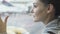 Close-up portrait of beautiful girl looking out window at airport on airplane background