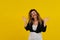 Close-up portrait of a beautiful girl on a yellow background. woman shows surprise. Shocked surprised stunned. positive human