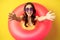 Close up portrait of beautiful happy woman inside pink swimming ring, luring, inviting people on summer vacation, beach