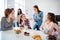 Close up portrait beautiful she her ladies family meeting sister cousins oh no faces stand sit round big white table