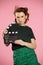 Close up portrait of a beautiful red haired girl holding film clapper. Teen girl holding classic black film making