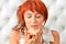 Close up portrait of beautiful redhead mature woman posing