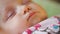 Close-up portrait of a beautiful sleeping baby in bed