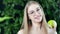 Close-up portrait of beautiful smiling European woman eating fresh organic apple looking at camera