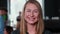 Close-up portrait of beautiful smiling young Caucasian blonde leader business woman posing at camera at trendy office.