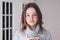 Close-up portrait of beautiful tween girl in warm grey pullover holding cup of tea looking at camera