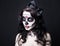 close up portrait of beautiful woman with creative Halloween skull make up over black