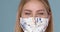 Close up portrait of beautiful woman wearing stylish face mask. Protection against viruses pollution