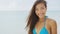 Close up portrait of beautiful young woman smiling on tropical beach slow motion