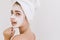 Close-up portrait of beautiful young woman with towels after take bath make cosmetic mask on her face. Rejuvenation