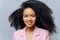 Close up portrait of beutiful happy curly haired prosperous business lady dressed formally, has curly luxurious hair, smiles