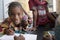 Close up Portrait of Black African Schoogirl Smiling and drawing on paper