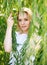 Close-up portrait blond woman in the branches of a willow