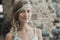 Close up portrait of blonde girl against background of stone wall