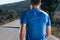 Close up portrait of a blonde, sweaty male runner athlete. Running on an empty road in the woods