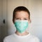 Close-up portrait of a boy in a medical mask