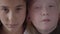 Close up portrait of brunette girl with brown eyes and albino girl with grey eyes looking at the camera. Concept of