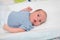 Close up portrait of caucasian cute newborn baby indoor lying on baby changing table in selective focus