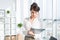 Close-up portrait of a caucasian female office assistant at her workplace. Confident clerk, standing, holding document