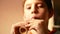 Close up portrait of caucasian preschooler boy playing the flute. Child performs a piece of music on a wood pipe, Selective focus,