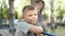 Close up portrait of caucasian teen boy. Funny teenager in summer park at day